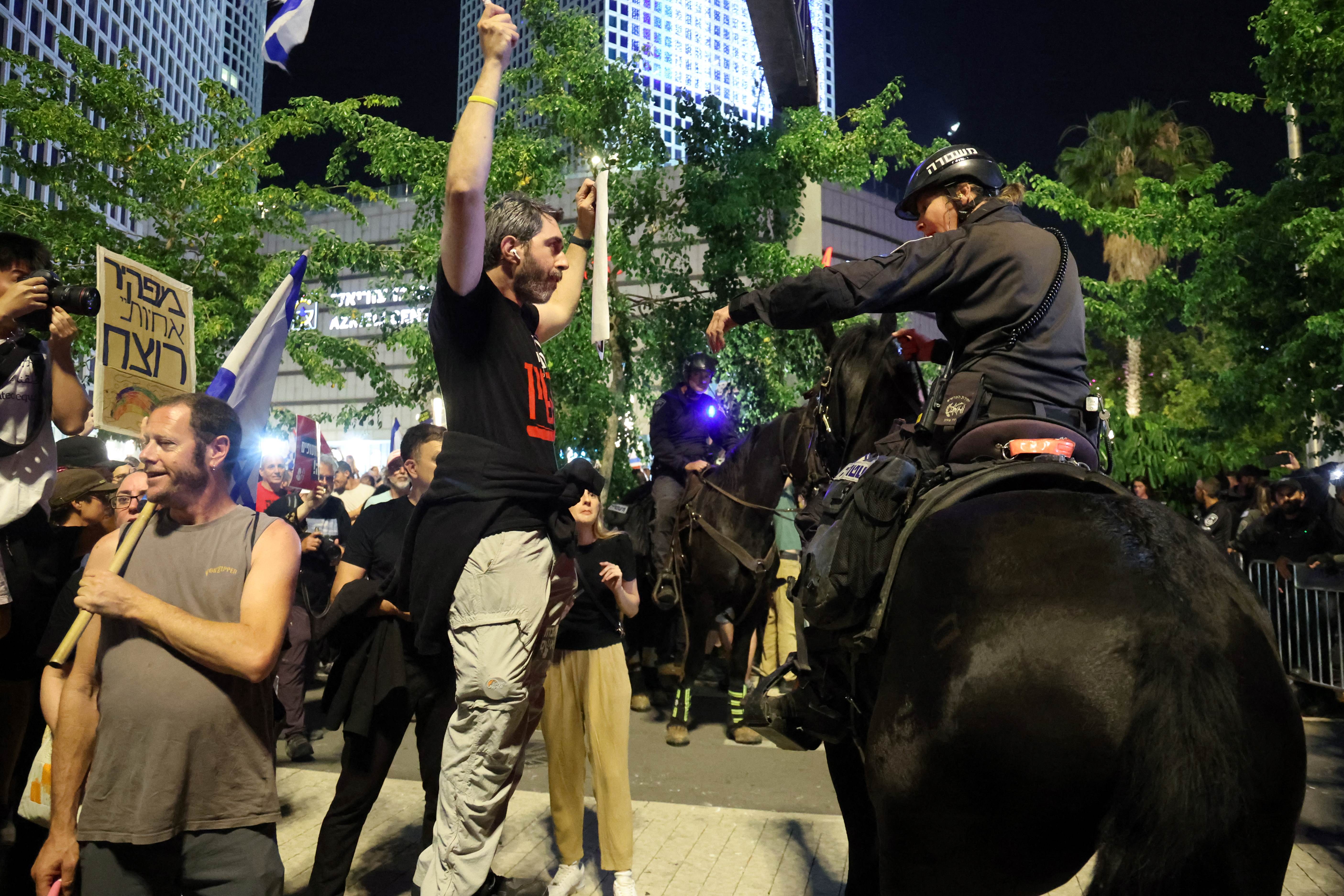 Israeli mounted police disperse anti-government protesters in Tel Aviv on 18 May (AFP/Jack Guez)